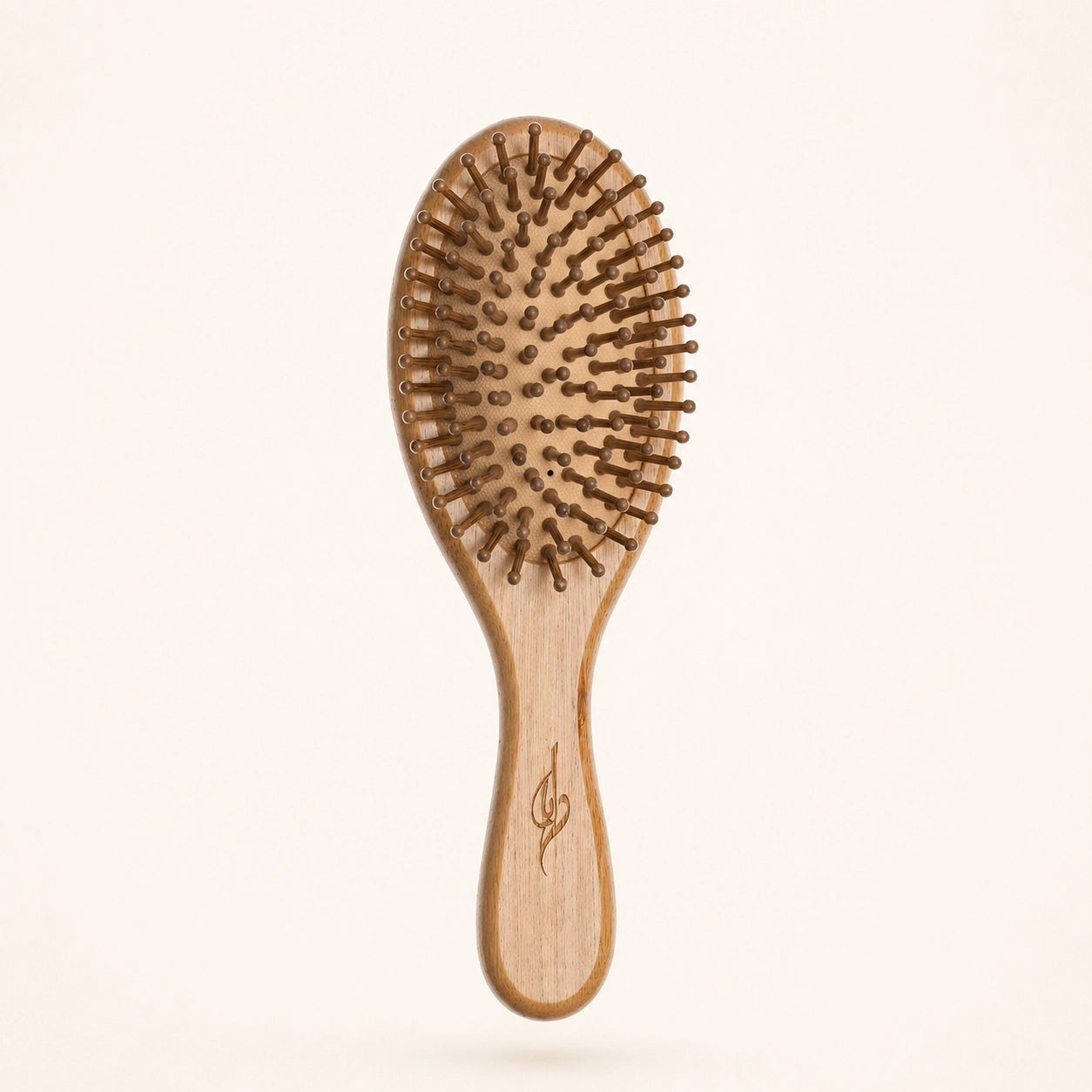 Bamboo hairbrush with bristle head on a beige background
