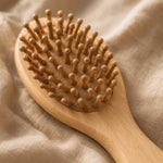 Bamboo kids hairbrush on a beige fabric background