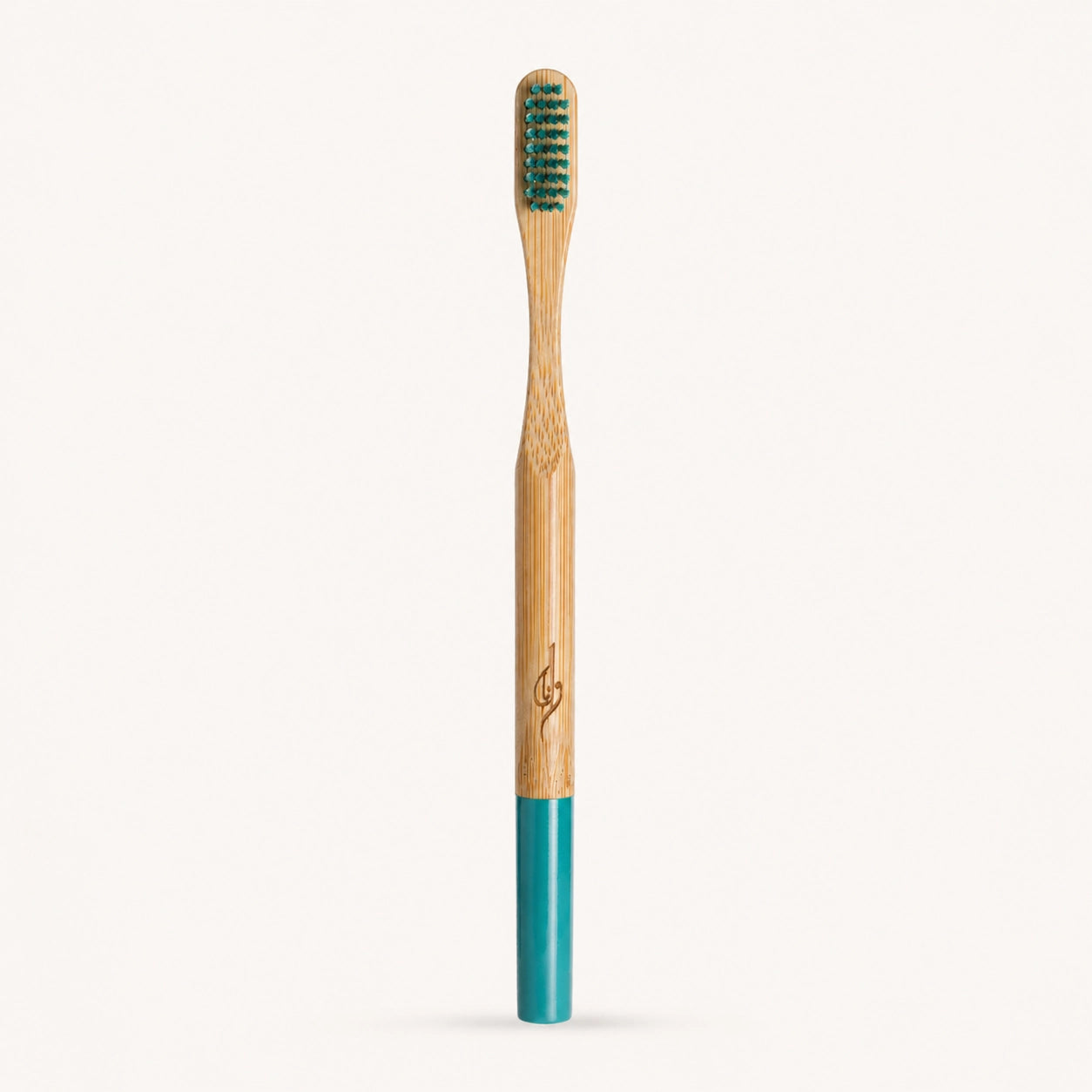 Bamboo toothbrush with green bristles and a blue handle on a white background