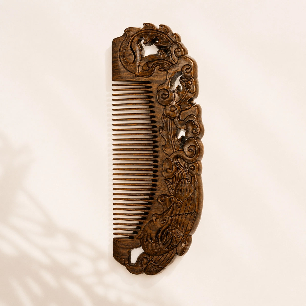 sandalwood comb with intricate carvings on a beige background
