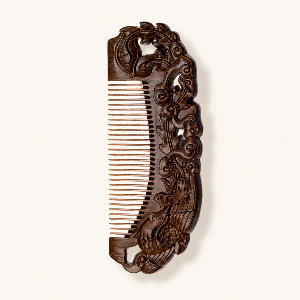Decorative sandalwood comb with intricate carvings on a white background
