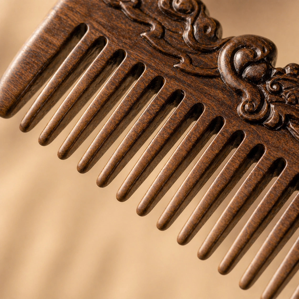 Close-up of a decorative sandalwood comb on a beige background