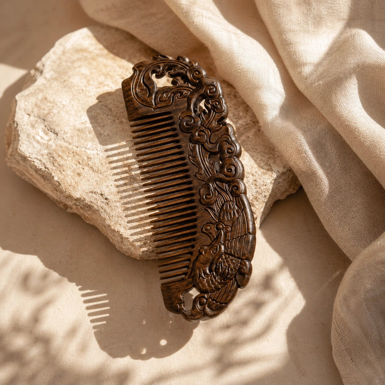 Decorative sandalwood comb on a textured beige surface
