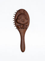 sandalwood kids hairbrush with a cartoon character design on a white background