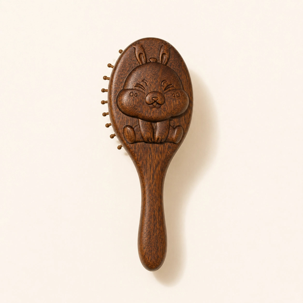 sandalwood kids hairbrush with a cartoon face design on a beige background
