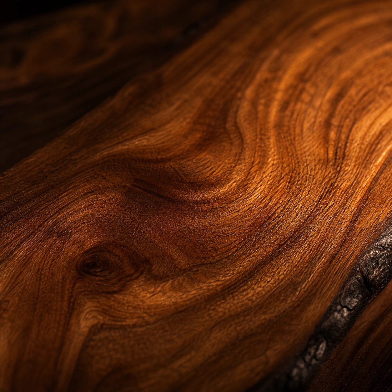 Close-up of a Sandalwood surface with a rich, warm brown color and visible grain.