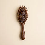 sandalwood hairbrush on a beige background